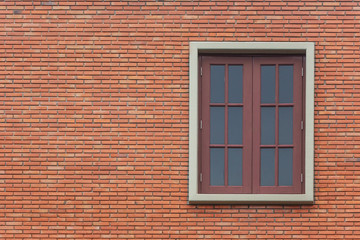 Red brick wall with window.