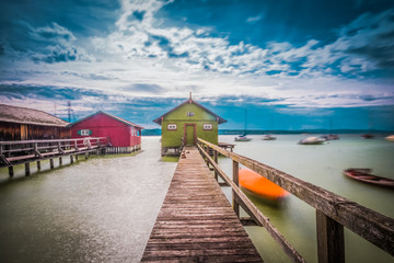 Old wooden dock houses on the lake with typical wooden pier