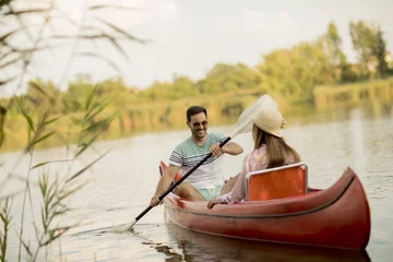 Foto op Canvas Loving couple rowing on the lake © BGStock72