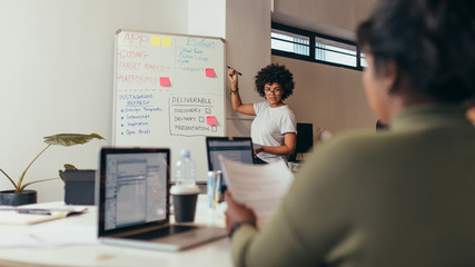 Woman giving presentation over new app development