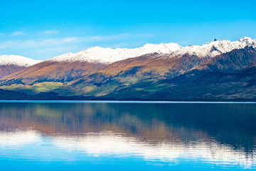 Stunning beautiful view beside lake Wanaka with alps mountain. Noon scenery with blue sky.