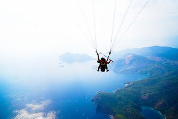 Fethiye, Mugla/Turkey- August 19 2018: Tandem paragliders on Mediterranean