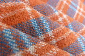 checkered orange woolen in blue cage close-up fabric