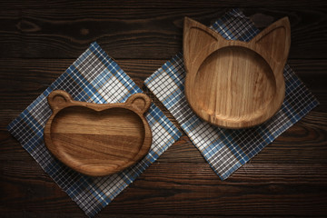Wooden plates kids on dark background, natural eco