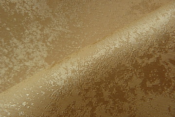 shiny golden fabric close-up of brocade organza