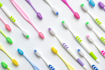 Top view,flat lay of toothbrushes in colorful on white background.