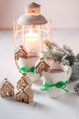 Fototapeta na wymiar Gingerbread cottages with hot cocoa for Christmas