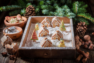 Homemade gingerbread village for Christmas in rustic table