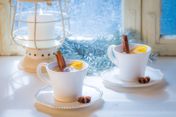 Hot tea with cinnamon for Christmas on white table