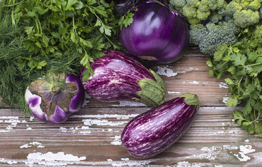 Organic vegetables eggplant for cooking natural vegetarian food on a wooden background.