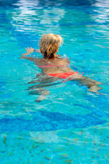 Woman swimming in the swimming pool