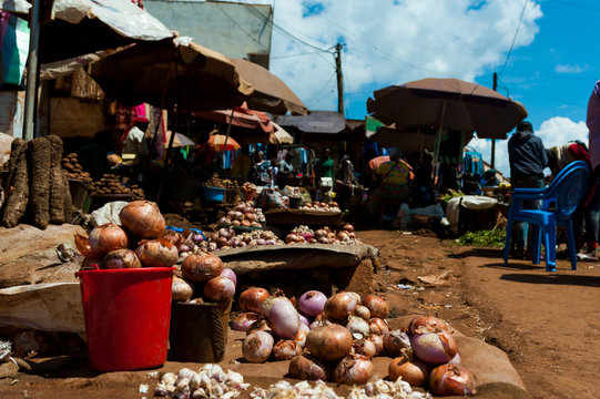 view of open air street market with food in cameroun during sunny summer day with blue sky