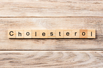cholesterol word written on wood block. cholesterol text on table, concept