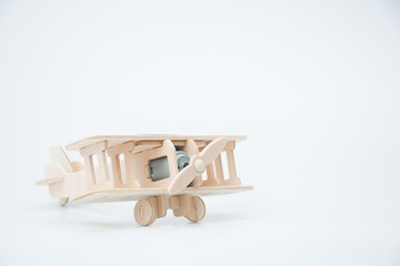 Wooden model plane on white background.