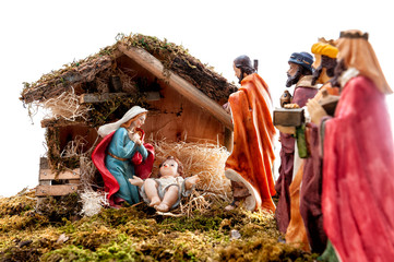 Christmas nativity scene with Holy Family in the hut and the three wise men, isolated on white...