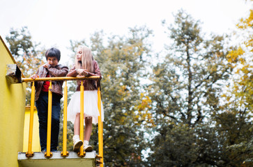 Boy and girl teenagers in autumn park