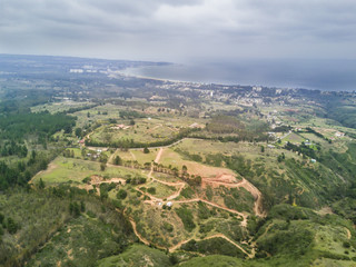 An aerial view of Chile countryside from the drone, hills, valleys and a rugged landscape from the near distance to an infinite horizon