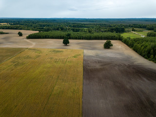 Obraz premium drone image. aerial view of rural area with fields and forests under dramatic storm clouds forming