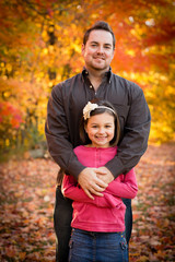 Happy Father and Daughter Standing in Autumn Park