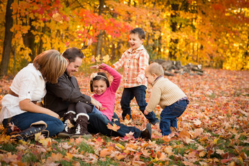Family Laughing and Playing in Autumn Park