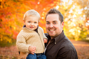 Fototapeta na wymiar Happy Father and Son in Autumn Park
