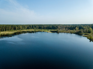 drone image. aerial view of rural area with fields and forest lake