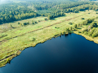 drone image. aerial view of rural area with fields and forest lake