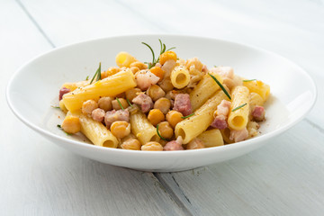 Dish of italian pasta with chickpeas and bacon 
