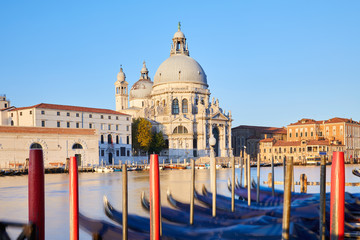 Fototapeta na wymiar Venice, Saint Mary of Health basilica and moored gondolas in a sunny morning, nobody