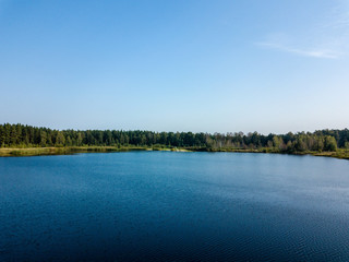 drone image. aerial view of rural area with fields and forest lake