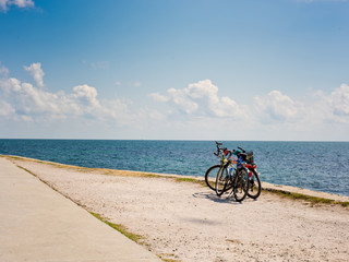 Fototapeta premium Two bicycles on the background of the sea and sky with clouds.