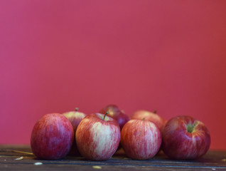 ripe red apples on pink background
