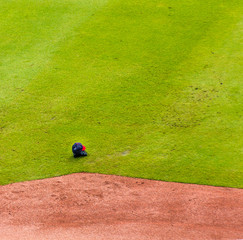 Cap and Glove on Baseball Field