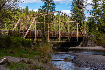 Fototapeta na wymiar Metal Bridge Spanning Deep Creek in Riverside State Park, Nine Nile Falls, Washington.