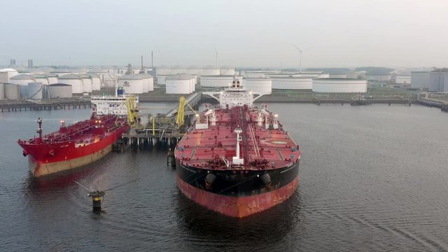 Supertanker Oil Ship Docked at Port for Offloading and Loading Fuels