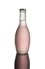 Glass bottle of pink soda with condensation on white background with reflection