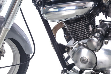 Close up of engine on vintage motorcycle on white background