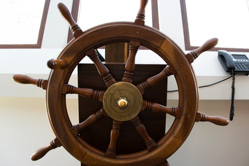 Front view of wooden rudder on a sailing ship inside the capitan's cabin © 682A_IA