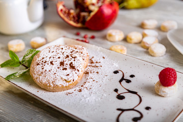 Close up view of beautiful elegant sweet dessert served on the plate. Beautiful decoration, restaurant dish, ready to eat. Tea time, cozy atmosphere.