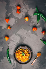 Mexican spice beans with sweet potato and tomato. Vegetarian chilli con carne on a clay plate. Top...