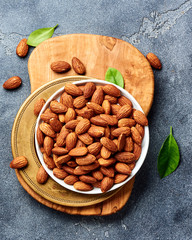 Almond nuts on gray background. Top view of roasted snacks.