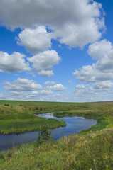 Fototapeta na wymiar Sunny summer landscape with river,fields,green hills and beautiful clouds in blue sky.Tula region,Russia. 