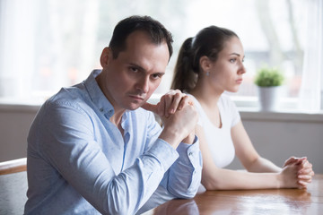 Stubborn couple avoid looking at each other after serious family fight, man and woman not talking...