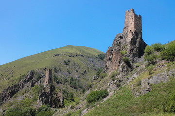 Fototapeta na wymiar Aerial view from the drone. Mountain Ingushetia, medieval tower complex Vovnushki-stone towers standing on the rocks.