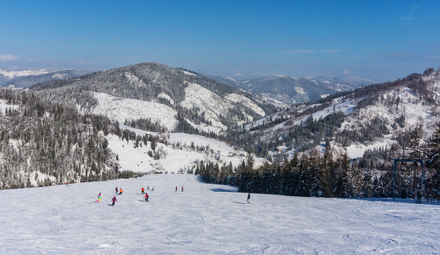 Skiers on the mountain slope on a background of mountains