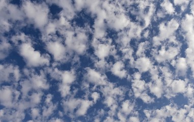 blue sky texture with fine white ragged clouds