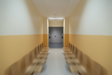 Hospital waiting room with empty chairs. motion radial blur effect