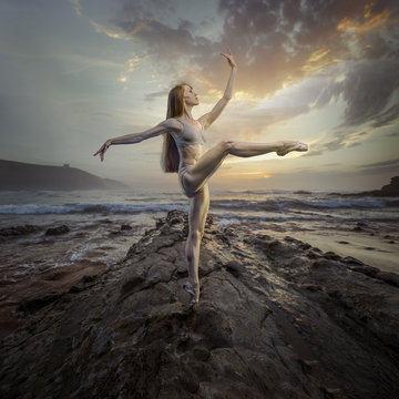 Ballet dancer in a sunset on the beach. concept freedom and nature in its purest state
