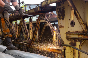 Cutting metal with a gas burner.