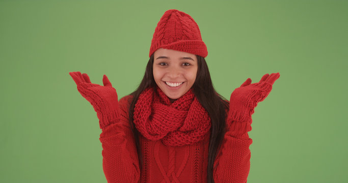 Laughing latina girl in red winter clothes looking happy on green screen